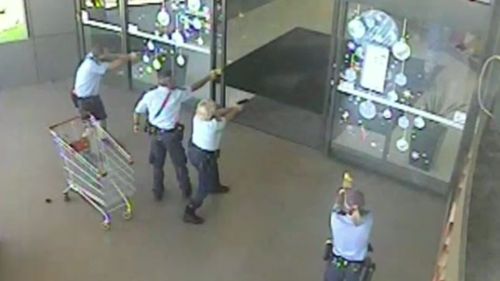 Police surrounded the entrance to the shopping centre with their tasers drawn after the man attempted to escape (9NEWS)