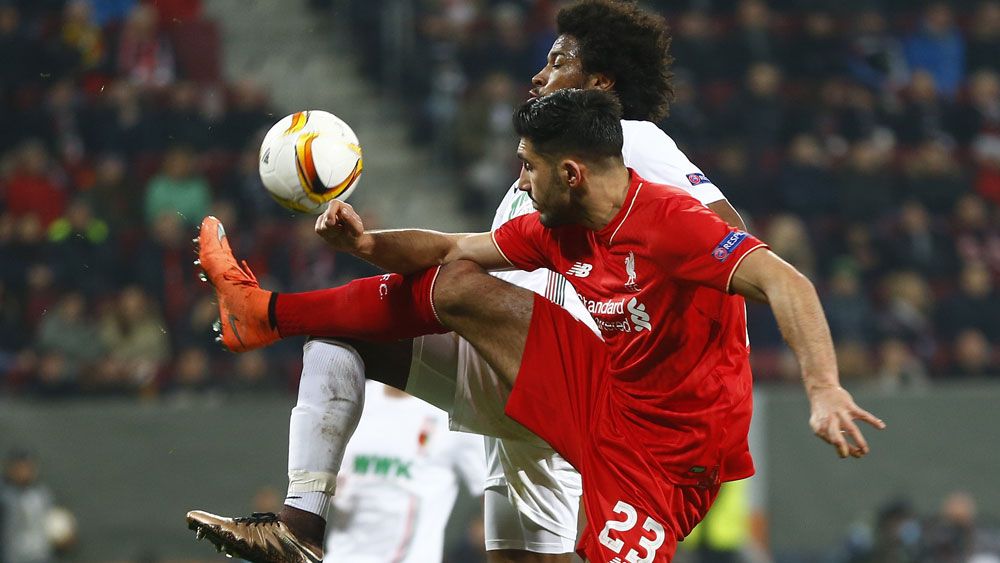 Augsburg's Caiuby, background, and Liverpool's Emre Can challenge for the ball during the Europa League clash. (AAP) 