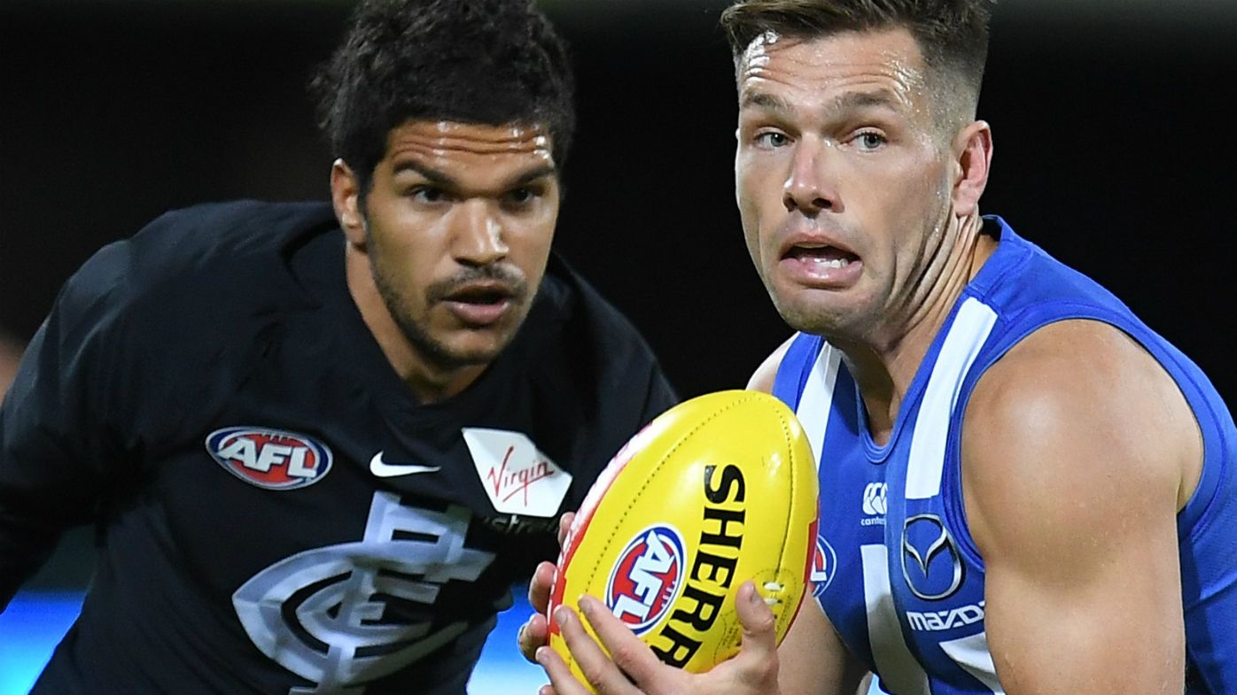 Shaun Higgins of the Kangaroos (right) and Sam Petrevski-Seton of the Blues contest during the Round 4 AFL match between the North Melbourne Kangaroos and the Carlton Blues at Blundstone Arena in Hobart, Saturday, April 14, 2018.