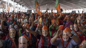 India election: Bharatiya Janata Party (BJP) supporters wear masks of Indian Prime Minister Narendra Modi during an election rally addressed by him in Meerut, India.