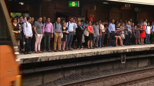 Commuters were late for work as 1300 services have been cut. (9NEWS)