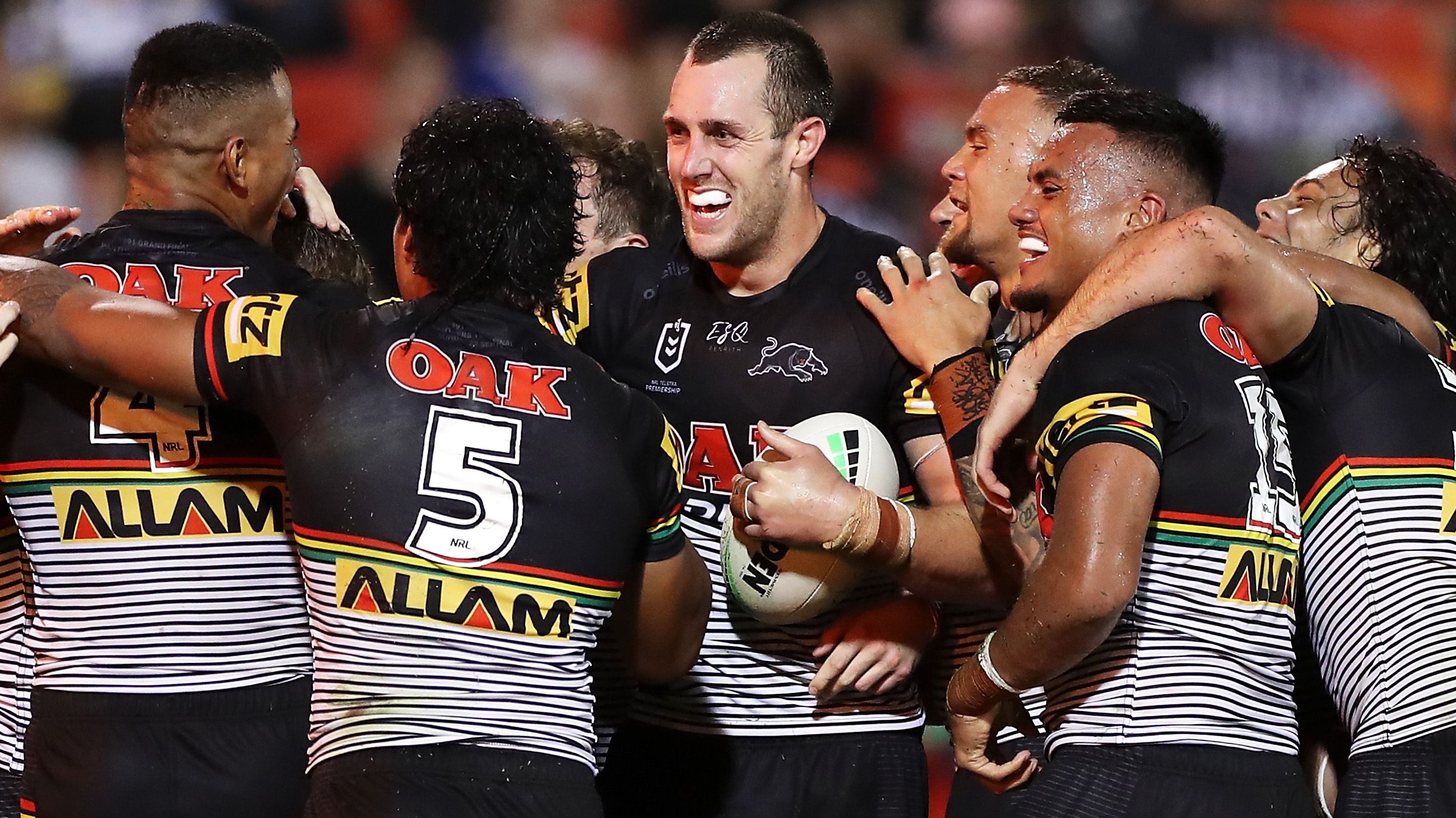 Isaah Yeo of the Panthers celebrates with his teammates after scoring a try.