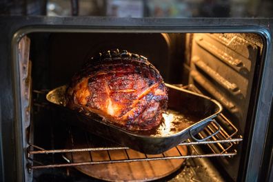 Honey roasted ham in roasting tin in oven