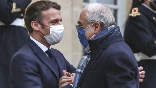 France's President Emmanuel Macron, left, welcomes OECD's Secretary General Angel Gurria for a working lunch at the Elysee Palace in Paris (Photo: December 14, 2020)