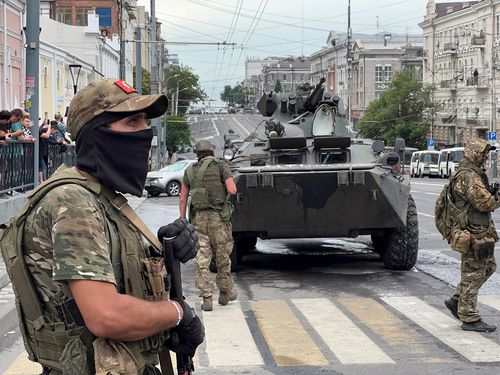 Fighters of Wagner private mercenary group stand guard in a street near the headquarters of the Southern Military District in the city of Rostov-on-Don, Russia, June 24, 2023. REUTERS/Stringer