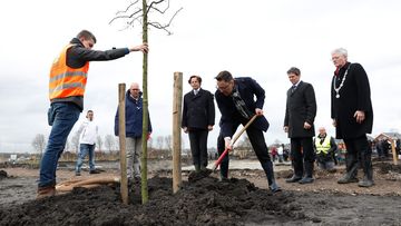 Dutch minister of Foreign affairs Bert Koenders (4nd L), Malaysia's Ambassador Ahmad Nazri Bin Yusof (C) and Tan Sri Mohamad Nor Yusof (3nd R), chairman of Malaysia Airlines, plant trees for the national monument in memory of the victims of the flight MH17 in Vijfhuizen on March 18, 2017. (AFP)