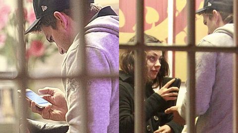 Sneaky: Ashton Kutcher caught checking Mila Kunis' phone