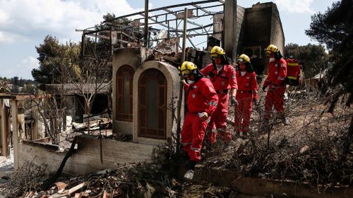 More than 280 firefighters remain in the area to the northeast of Athens in the wider Rafina area, dousing the remaining flames to prevent flare-ups. Picture: AP