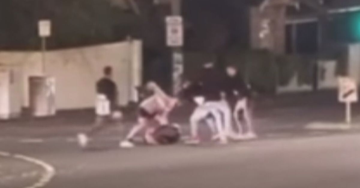 Man charged after AFL fans filmed brawling on Melbourne road - 9News