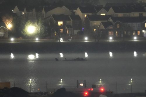The wreckage of a Black Hawk helicopter is pictured in the Potomac River from Ronald Reagan Washington National Airport, Friday, Jan. 31, 2025, in Arlington, Va. (AP Photo/Alex Brandon)