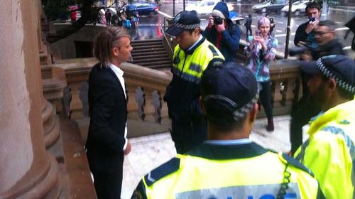 Jesse Willesee was arrested at 4.21pm, just one minute after he dared to light a joint on the steps of Sydney Town Hall. (Supplied)