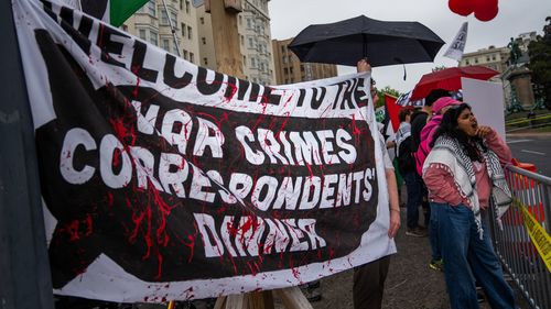 Protesters demonstrate outside of the White House Correspondents Dinner, Saturday, April 25, 2026, in Washington. 