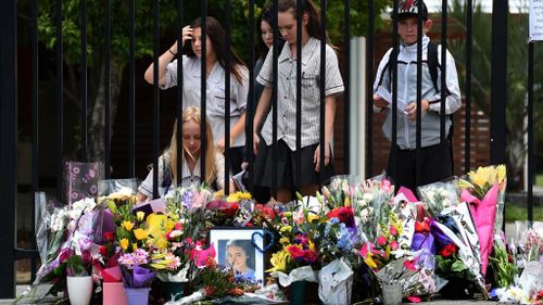 Fellow students place floral tributes for Tiahleigh. (AAP)