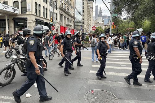 New York Police wearing riot gear patrol around Union Square, Friday, Aug. 4, 2023, in New York. 