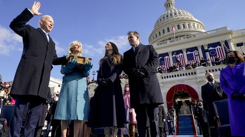 Joe Biden is sworn in as the 46th president of the United States at the Capitol in Washington, Wednesday, Jan. 20, 2021, as his wife Jill Biden holds a bible and his daughter Ashley Biden and son Hunter Biden look on. (Andrew Harnik/Pool via The New York Times) -- FOR EDITORIAL USE ONLY --