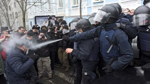 Ukrainian police use tear gas on supporters of Mikheil Saakashvili in Kiev. (AAP)