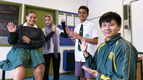 (l-r) Keti Leaaetoa, Masoomah Rezai,Mohammad Dahbach, and Andy Chen signing Auslan. Auslan joins the NSW curriculum alongside redesigned language syllabuses. Strathfield High School. March 18, 2022. Photo: Rhett Wyman/SMH