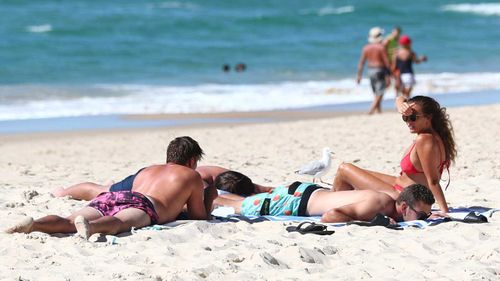 People relax on the beach at Burleigh Heads on the Gold Coast.