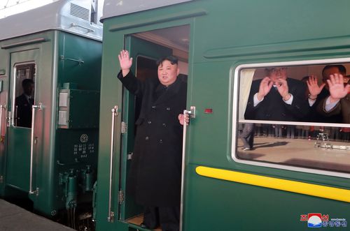 The North Korean leader waving as he boards a train in Pyongyang, North Korea.