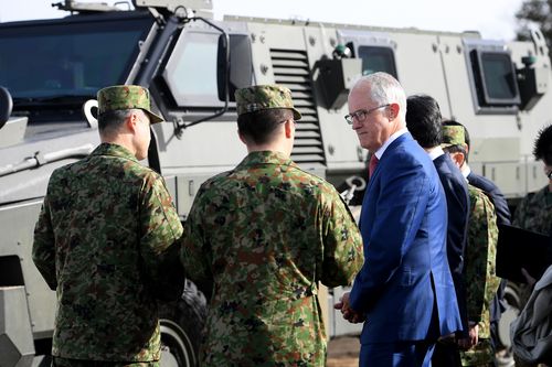 Australian Prime Minister Malcolm Turnbull and Japanese Prime Minister Shinzo Abe inspect the Patriot Missile system and Australian made Bushmaster Protected Mobility vehicle at a Japan Ground Self Defence Force (JGSDF) base at Narashino, Japan. (AAP)
