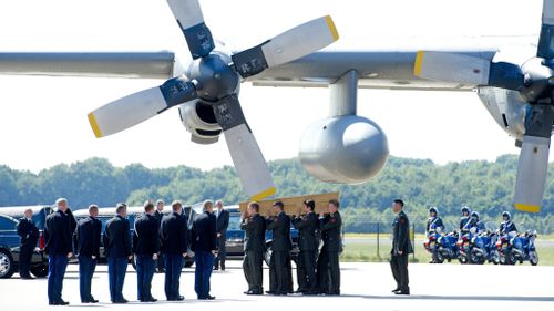 Grieving relatives and a military escort have received the first 40 victims of flight MH17, after two planes arrived at Eindhoven Airbase in the Netherlands. (Getty Images)