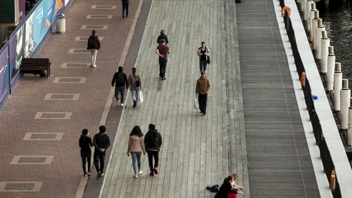 Generic. Commuters, pedestrians, in Darling Harbour, Sydney on August 4, 2020. coronavirus. 