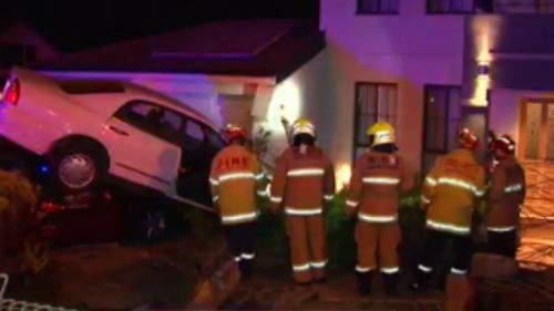 A driver has crashed their car on top of a parked vehicle in Sydney. (9NEWS)