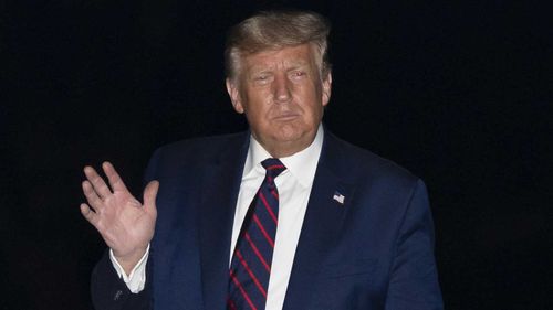 President Donald Trump waves after stepping off Marine One on the South Lawn of the White House.