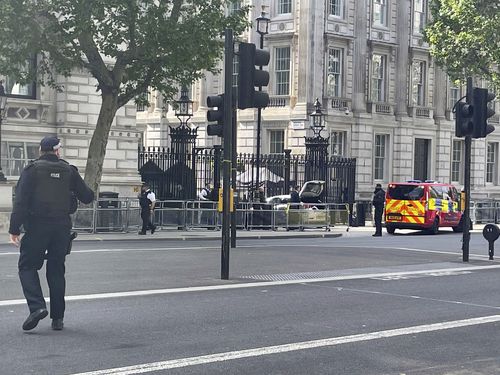 Police at the scene after a car collided with the gates of Downing Street, in London, Thursday May 25, 2023. 