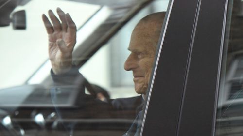 Prince Philip waves as he leaves hospital. (AP/AAP)