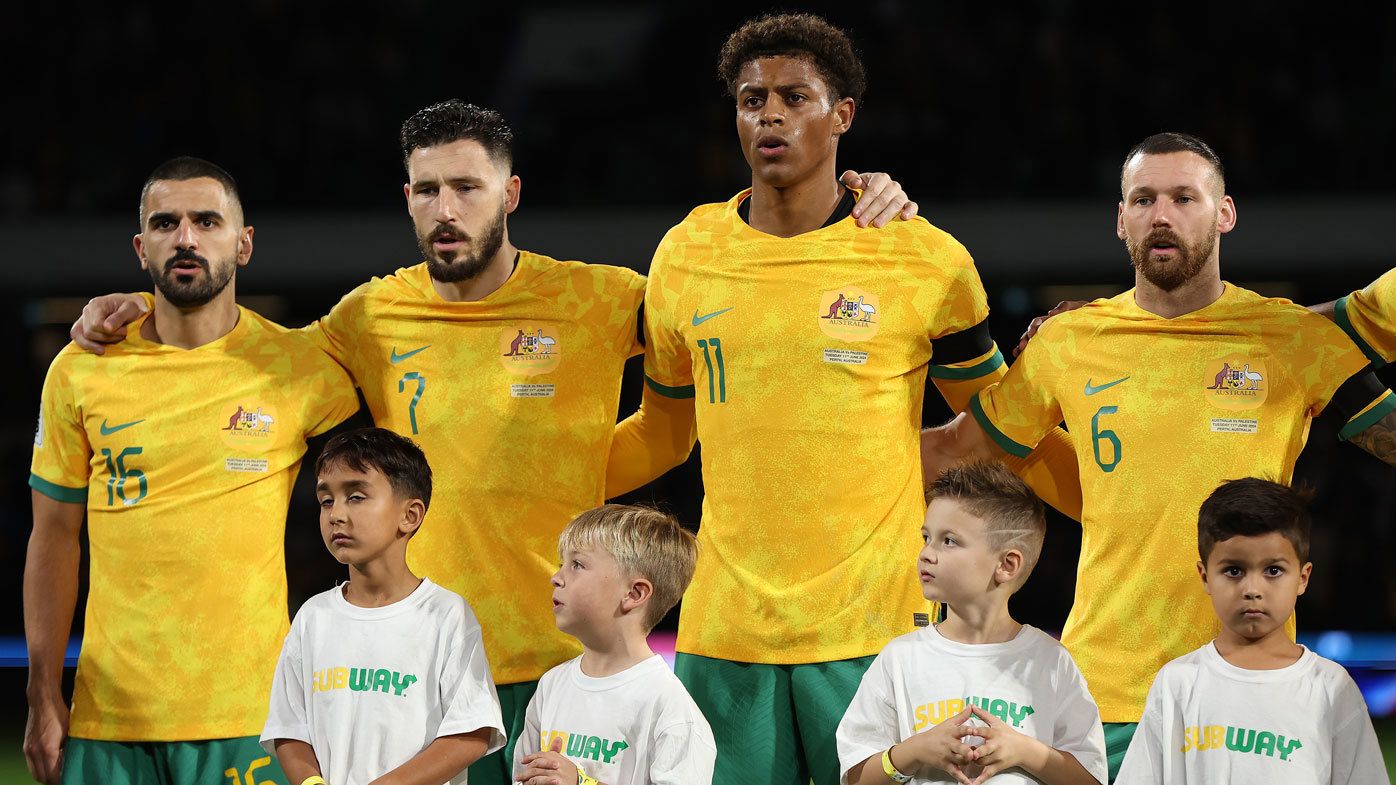 Socceroos players Aziz Behich, Mathew Leckie, Kusini Yengi and Martin Boyle line up for the anthem ahead of a World Cup qualifier against Palestine.