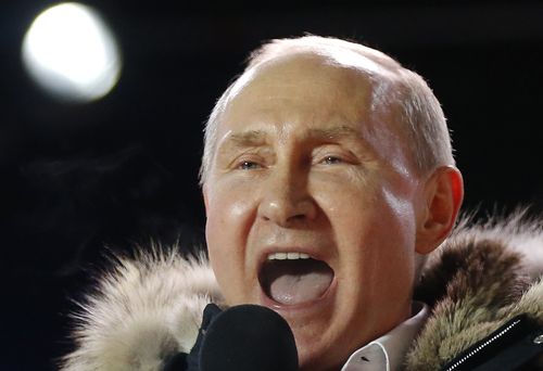 Russian President Vladimir Putin speaks to supporters during a rally near the Kremlin in Moscow, Sunday, March 18, 2018. An exit poll suggests that Vladimir Putin has handily won a fourth term as Russia's president, adding six more years in the Kremlin for the man who has led the world's largest country for all of the 21st century. (AP Photo/Alexander Zemlianichenko)