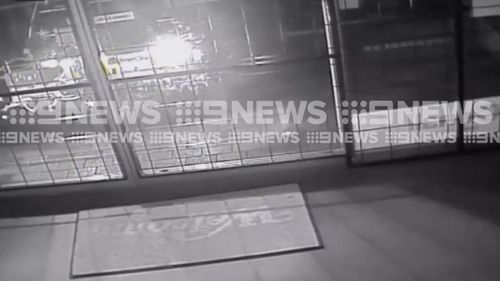 The car is seen reversing into the entrance. (9NEWS)