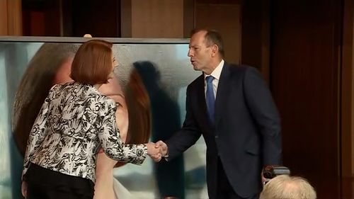 Ms Gillard and Mr Abbott shake hands - finally.