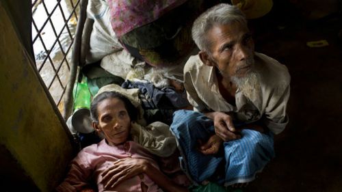 Newly arrived Rohingya Jamie Hasan, right, and his wife Hag Bano rest inside a school in Kutupalong refugee camp, Bangladesh. (AP)
