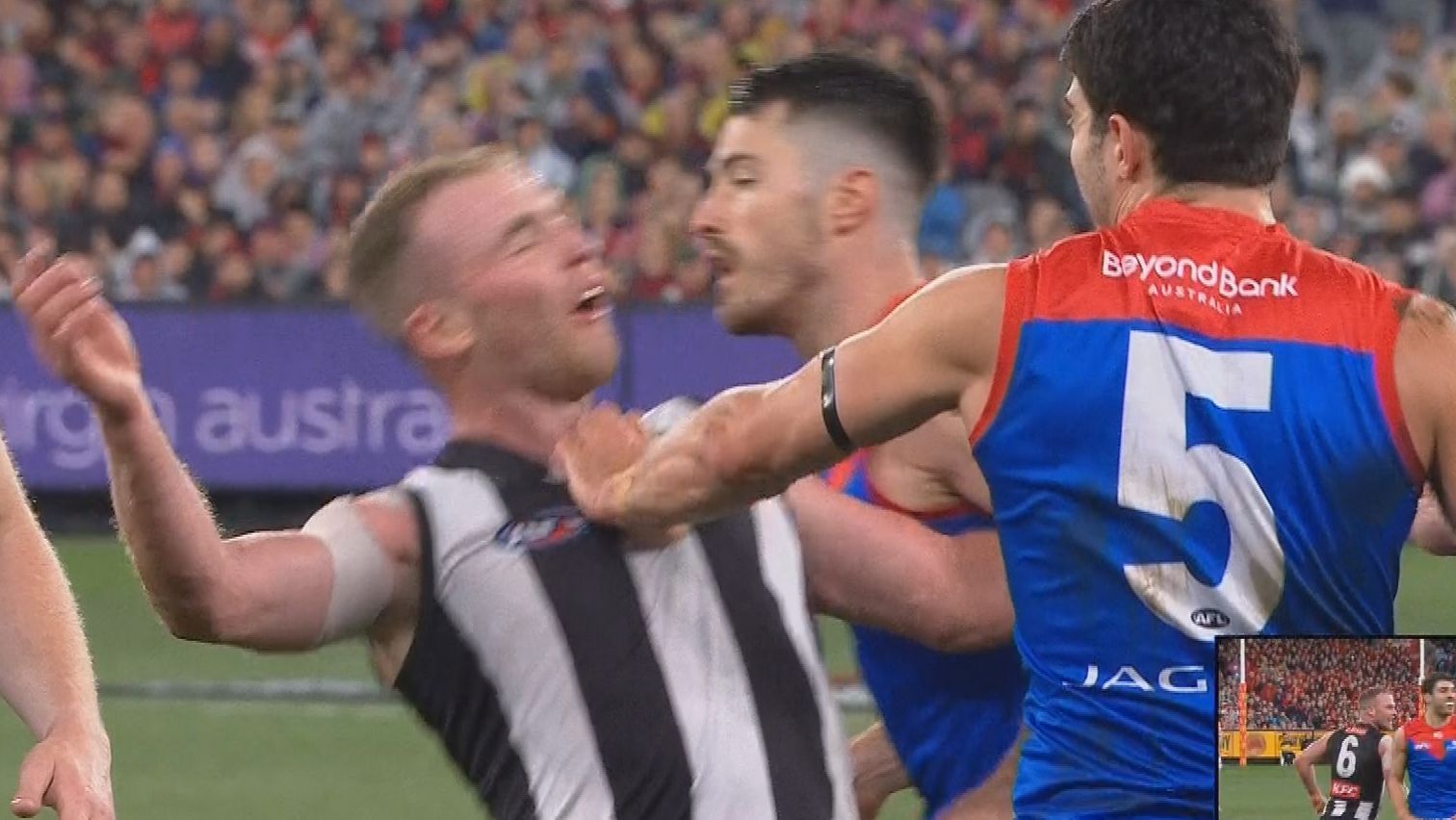 Collingwood&#x27;s Tom Mitchell flopped to the turf after a soft shove from Christian Petracca.