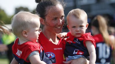 Daisy Pearce of the Demons is seen with her children Sylvie and Roy after a win during the 2020 AFLW Round 01 match.