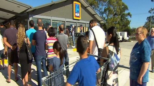 People line up at some stores for hours to take advantage of the low prices.