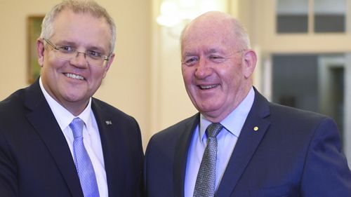 Australian Prime Minister Scott Morrison shakes hands with Australian Governor-General Sir Peter Cosgrove during a swearing-in ceremony at Government House in Canberra.