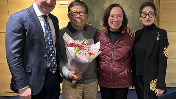 Chau Van Kham with his wife, Quynh Trang Truong, both centre, and Kham&#x27;s lawyer (right) and MP Chis Bowen (left).