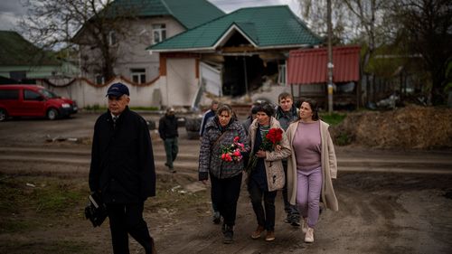 Tetiana Boikiv, 52, centre, walks with friends and neighbors during a funeral service for her husband, Mykola "Kolia" Moroz.