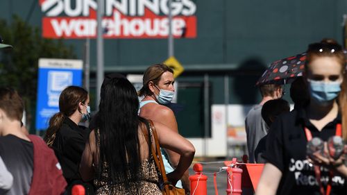 People queue to receive a Covid-19 vaccine at a Bunnings hardware store in Brisbane.