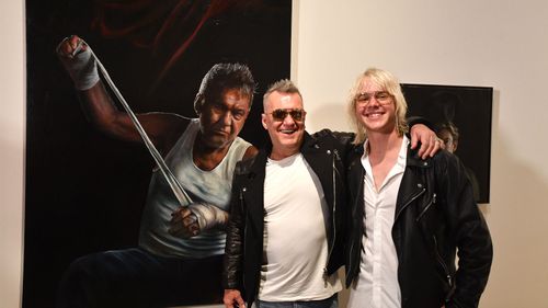 Artist Jamie Preisz and entertainer Jimmy Barnes pose with the Packing Room Prize winning portrait at the Art Gallery of New South Wales in Sydney, Thursday, May 3, 2018. (AAP Image/Mick Tsikas)