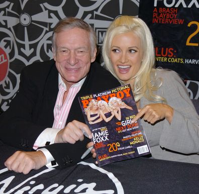 Hugh Hefner and Holly Madison  sign the November 2005 Issue of Playboy in New York in 2005.