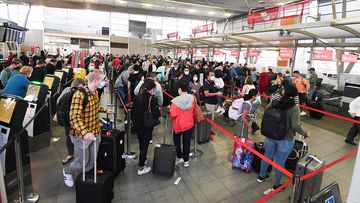 Easter holiday travellers at Sydney Domestic Airport yesterday. Long queues are expected over the long weekend.