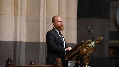 Husband Michael Johnson speaks to supporters attending a memorial service at St Paul's Cathedral in Melbourne. (AAP)