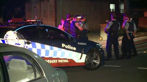 A man at the property launched himself at an officer armed with a knife. (9NEWS)