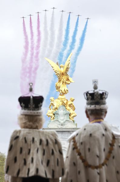 King Charles III and Queen Camilla watch the Red Arrows from the balcony of Buckingham Palace after their coronation, in London, Saturday, May 6, 2023.