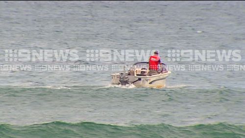 Lifesavers went out in the water to clear swimmers. (9NEWS)