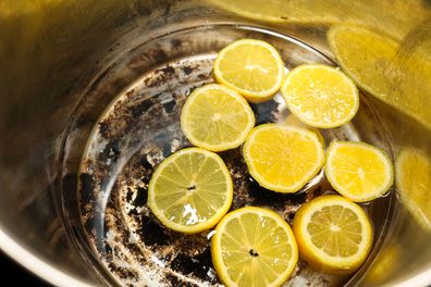 Sliced Lemons Inside Of A Burnt Cooking Pot